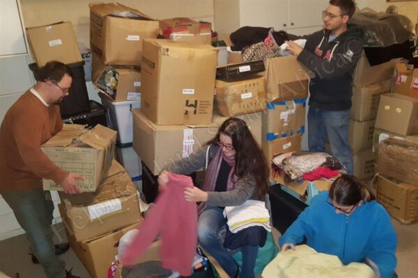 Here you see the young people of Helping Hand sorting and folding winter items in preparation for upcoming projects!